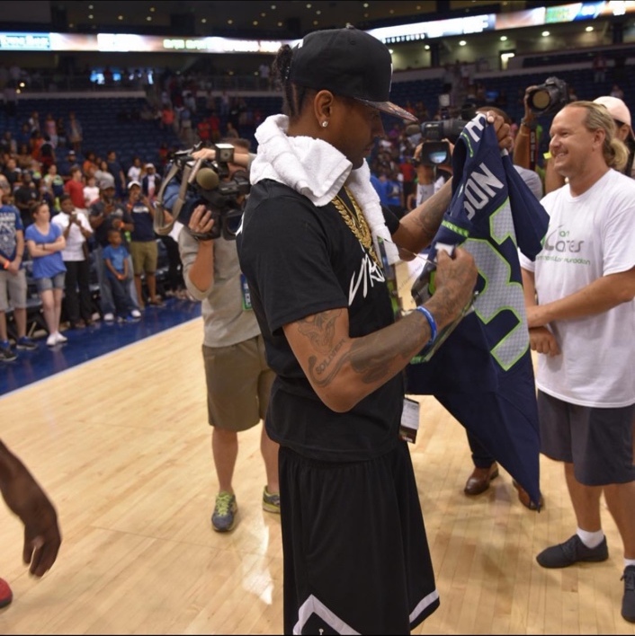 Allen Iverson receiving a personalized Seattle Seahawks jersey while Shaggy looks on