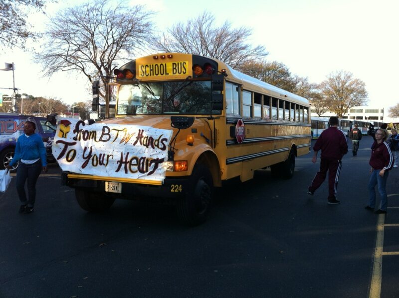 A school bus decorated with a community banner during Stuff the Bus in 2010