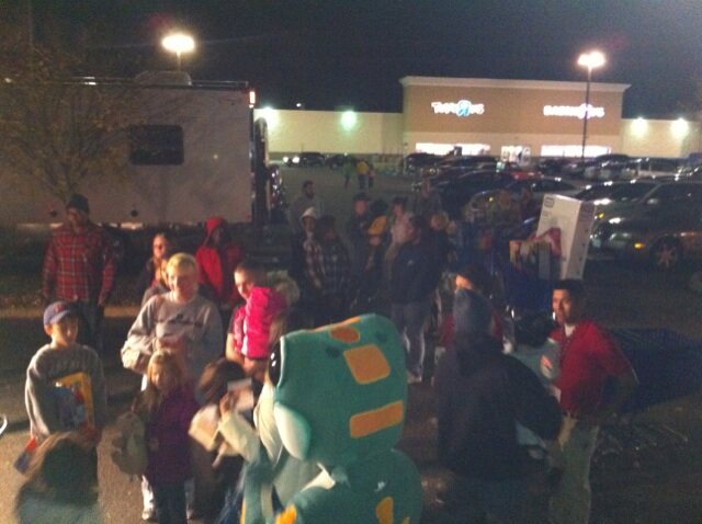 A crowd bringing donations to Stuff the Bus at night in 2010